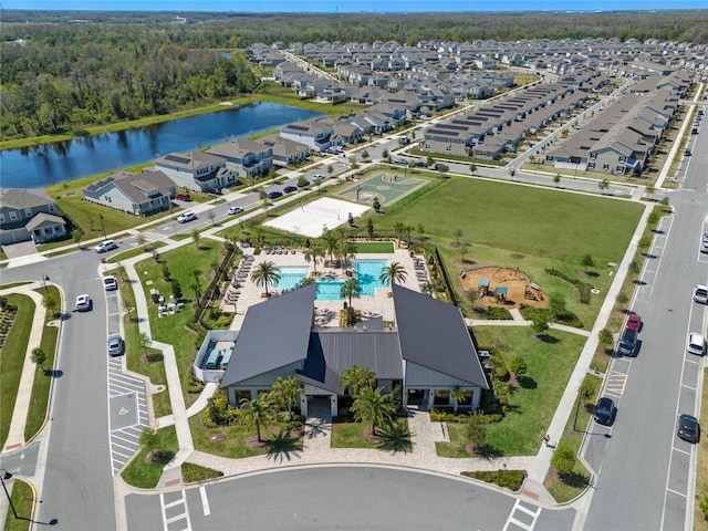 birds eye view of property with a residential view and a water view