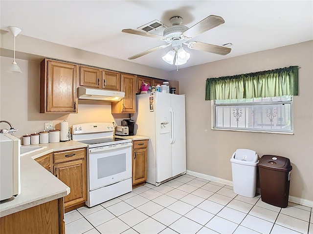 kitchen with brown cabinets, light countertops, ceiling fan, white appliances, and under cabinet range hood