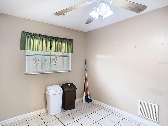 spare room featuring a ceiling fan, visible vents, baseboards, and light tile patterned flooring