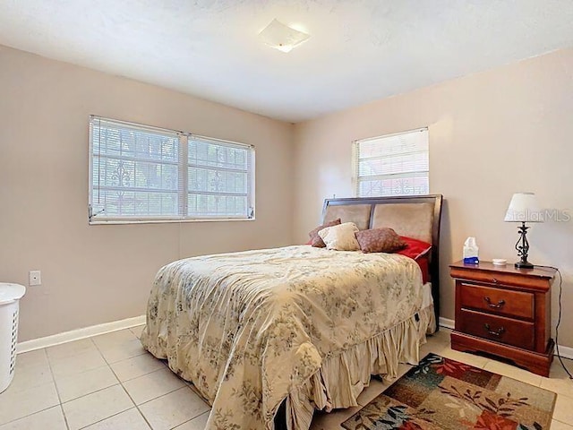 bedroom with baseboards and light tile patterned flooring