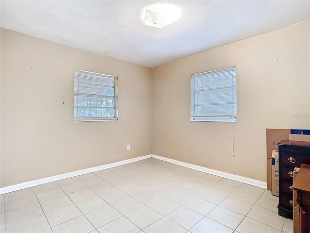 spare room featuring baseboards