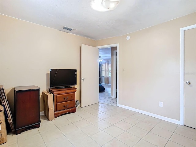 living room with visible vents, baseboards, and light tile patterned floors