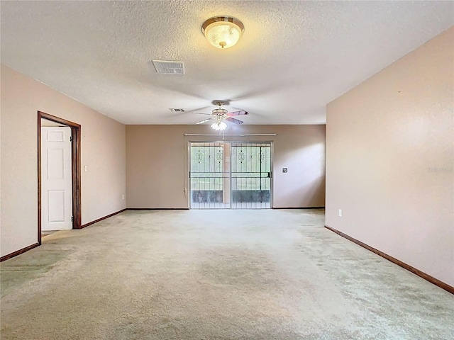 unfurnished room with light carpet, visible vents, and baseboards