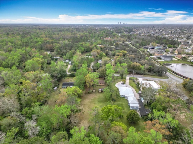 drone / aerial view featuring a forest view