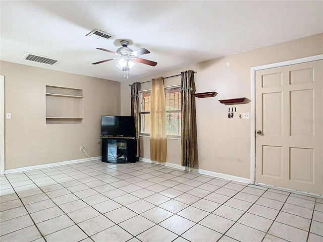 unfurnished living room with ceiling fan, light tile patterned flooring, visible vents, and baseboards