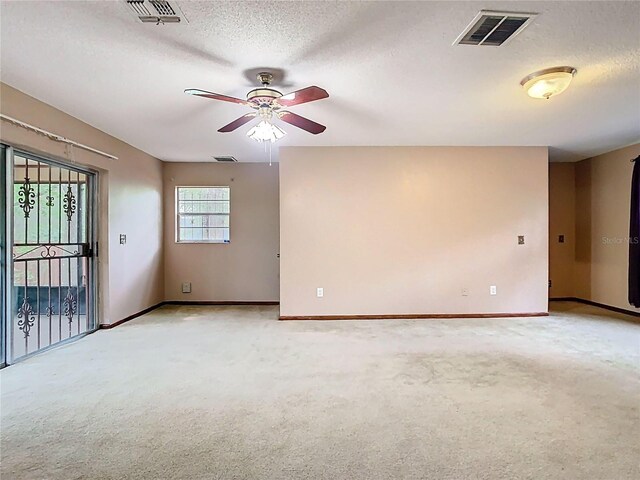15523 Old Cheney Hwy, Orlando, FL 32828 - unfurnished room with light colored carpet, ceiling fan, baseboards, and a textured ceiling