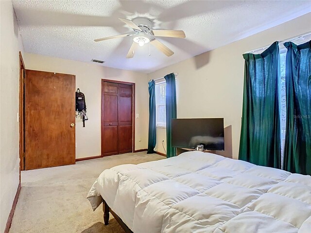 15523 Old Cheney Hwy, Orlando, FL 32828 - bedroom featuring light colored carpet, a textured ceiling, baseboards, and a ceiling fan