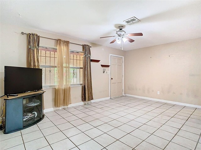 15523 Old Cheney Hwy, Orlando, FL 32828 - unfurnished living room featuring ceiling fan, light tile patterned flooring, and baseboards