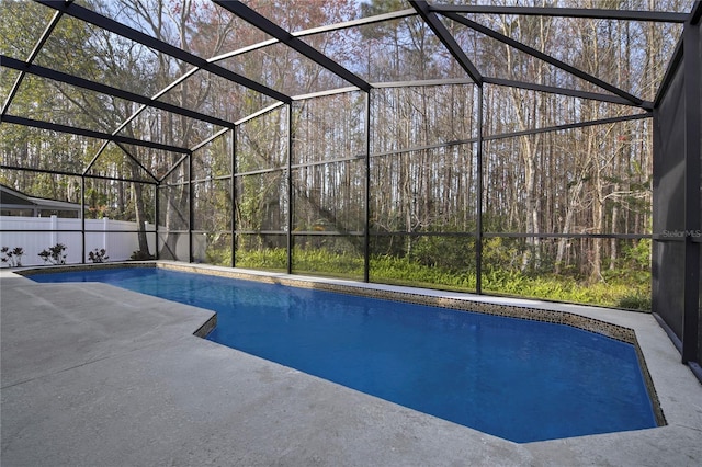 pool featuring glass enclosure and a patio