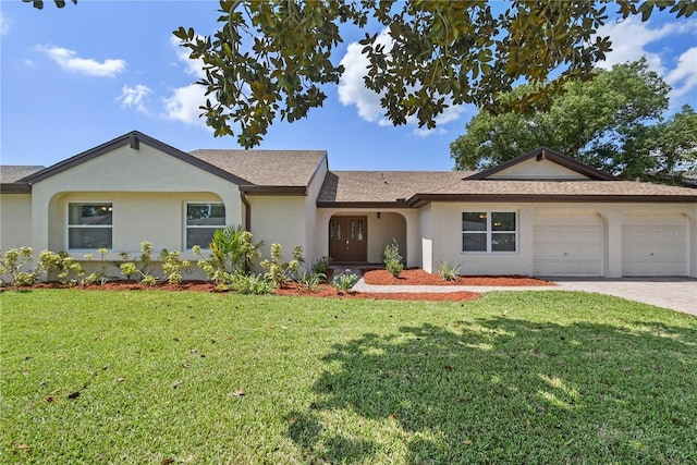 ranch-style home with a front yard, decorative driveway, an attached garage, and stucco siding