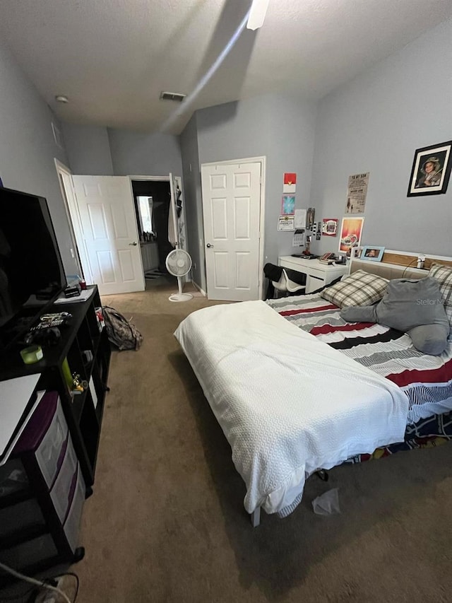 carpeted bedroom featuring visible vents