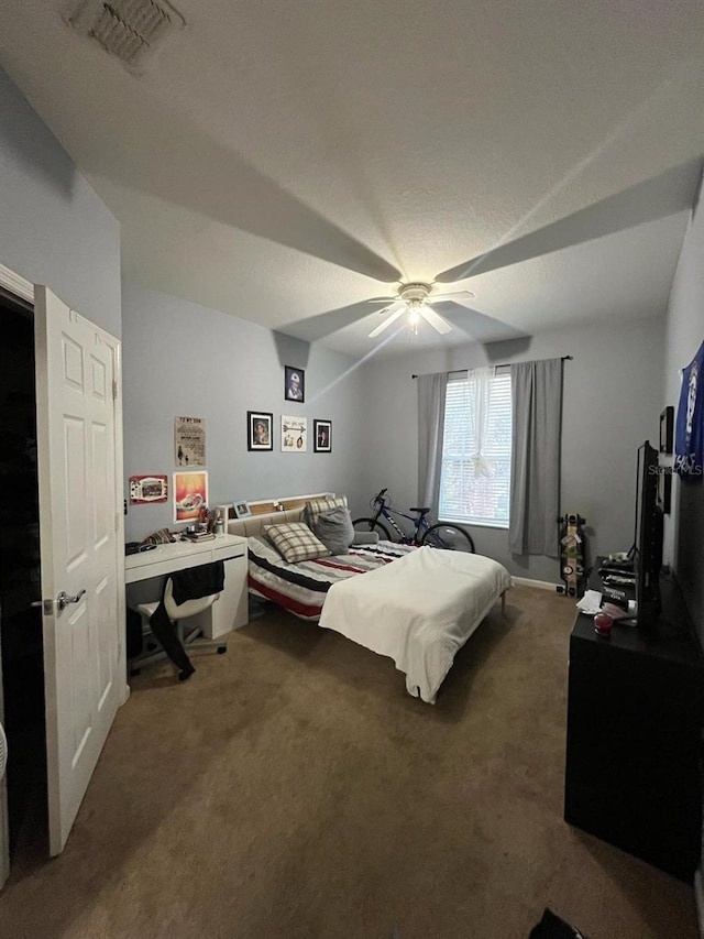 carpeted bedroom featuring visible vents and ceiling fan