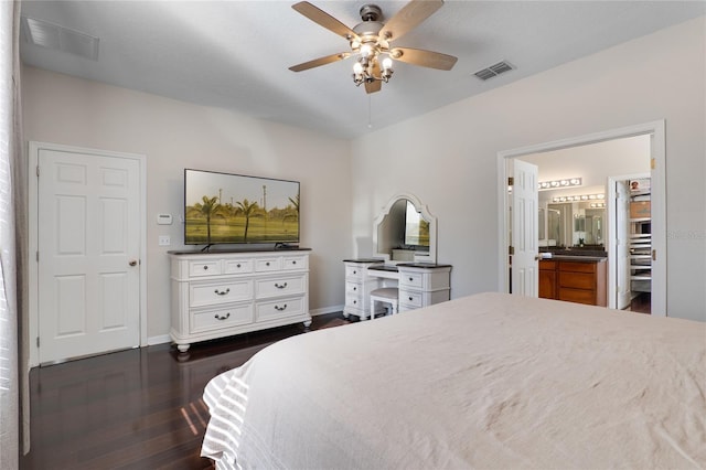 bedroom with dark wood finished floors, visible vents, and baseboards