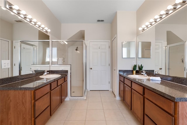 bathroom featuring tile patterned flooring, a sink, and visible vents