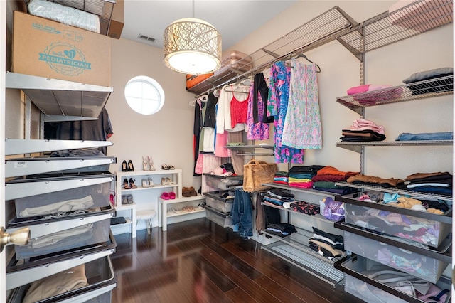 spacious closet featuring wood finished floors and visible vents