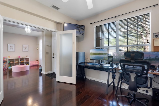 office space with visible vents, ceiling fan, baseboards, and wood finished floors