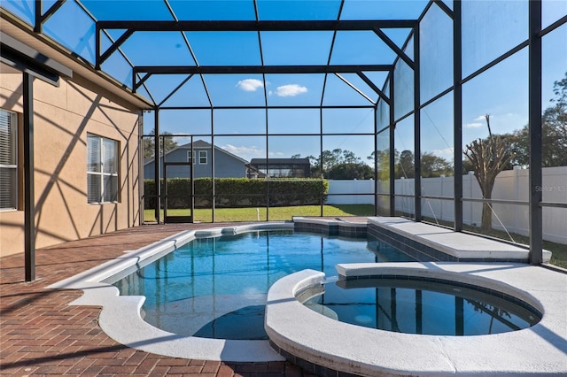 view of swimming pool with glass enclosure, a fenced backyard, a patio area, and a pool with connected hot tub