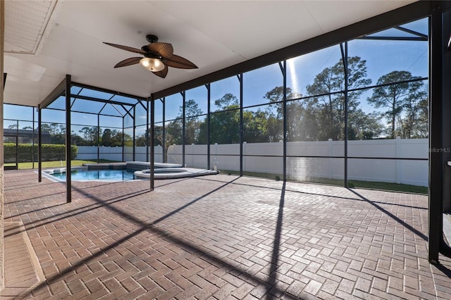 view of pool with a ceiling fan, glass enclosure, fence, a patio area, and a pool with connected hot tub