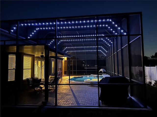 exterior space featuring an outdoor pool, a lanai, a patio, and a ceiling fan