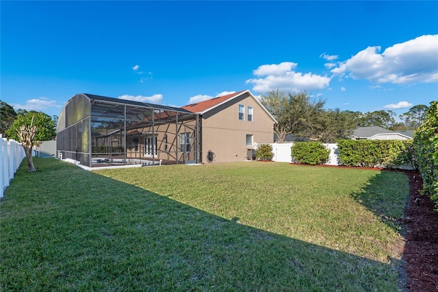 view of yard featuring a fenced backyard and a lanai