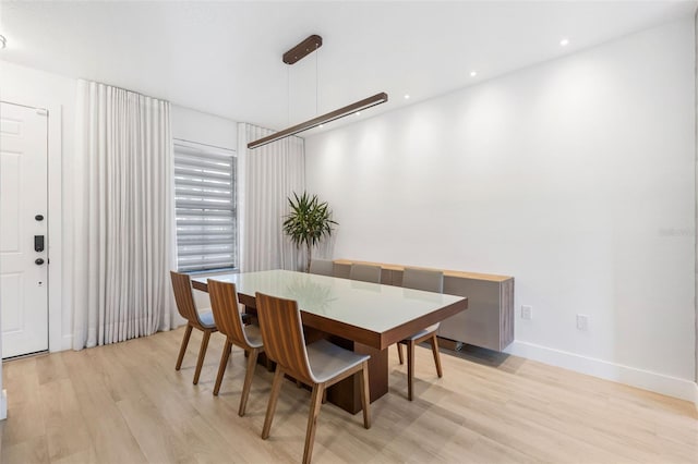 dining area with light wood finished floors, baseboards, and recessed lighting