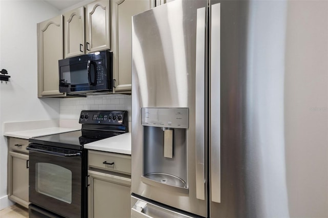 kitchen featuring tasteful backsplash, light countertops, and black appliances