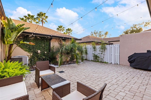 view of patio / terrace with an outdoor living space, central AC, fence, and grilling area