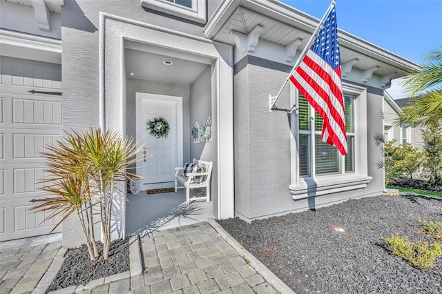 view of exterior entry with a garage