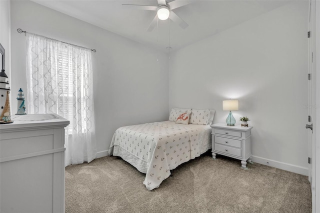 carpeted bedroom featuring a ceiling fan and baseboards