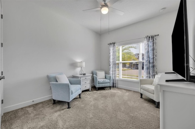 sitting room with carpet floors, ceiling fan, and baseboards