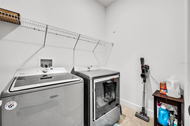 laundry area featuring laundry area, independent washer and dryer, and baseboards