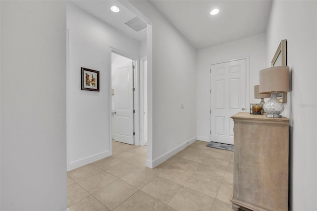 foyer entrance featuring light tile patterned floors, baseboards, visible vents, and recessed lighting