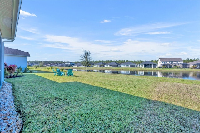 view of yard with a water view and a residential view