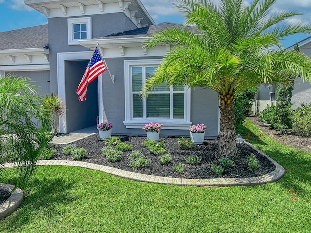 585 Mosaic Blvd, Daytona Beach, FL 32124 - exterior space with a garage, stucco siding, and a yard