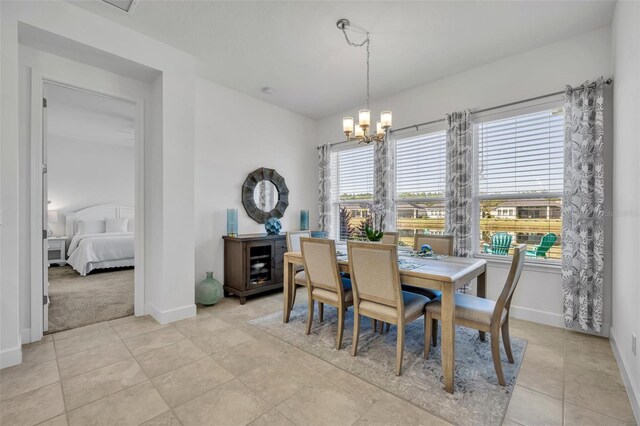 585 Mosaic Blvd, Daytona Beach, FL 32124 - dining room with an inviting chandelier, baseboards, and light tile patterned floors