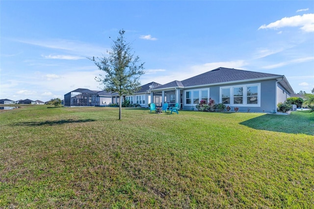 585 Mosaic Blvd, Daytona Beach, FL 32124 - rear view of house with a lawn