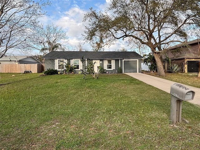 ranch-style house with a garage, driveway, a front lawn, and fence