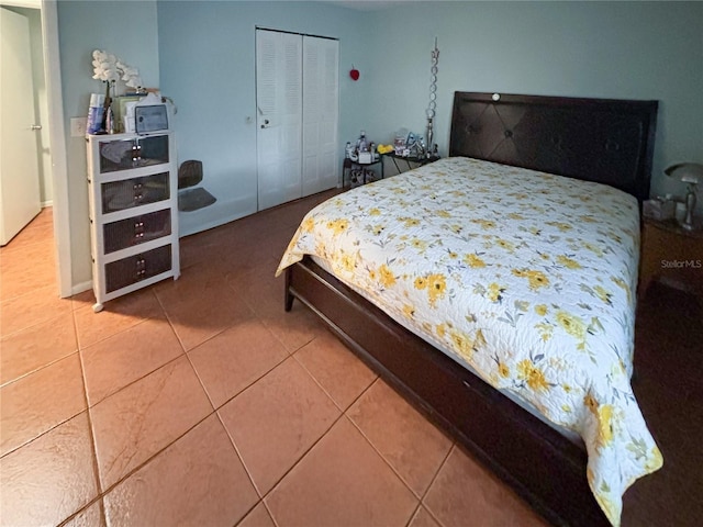 tiled bedroom with a closet