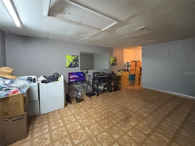 interior space with attic access, washing machine and clothes dryer, and tile patterned floors