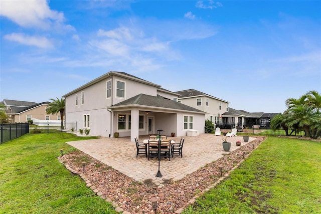 back of property featuring a patio area and stucco siding
