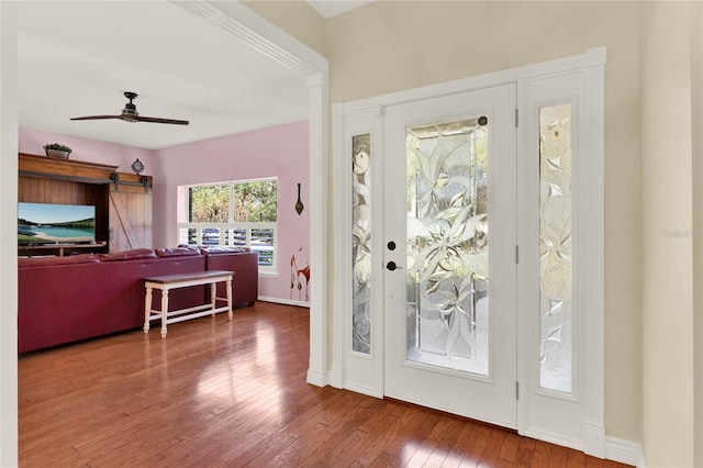 entrance foyer featuring ceiling fan, baseboards, and hardwood / wood-style floors