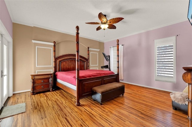 bedroom with light wood-style floors, baseboards, and crown molding