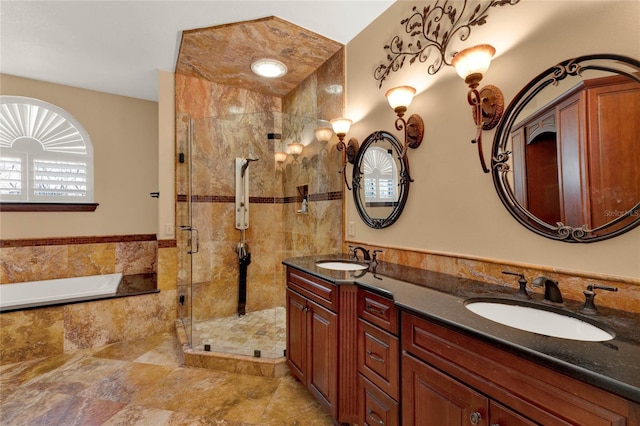 full bathroom with a garden tub, double vanity, a stall shower, and a sink