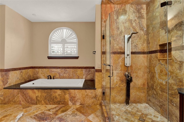 bathroom featuring a garden tub and a shower stall