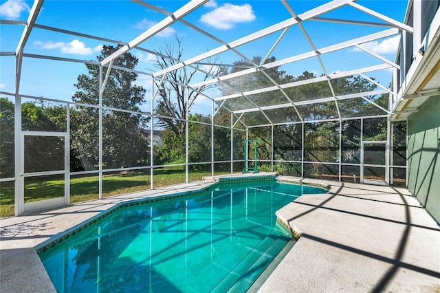 pool with glass enclosure and a patio