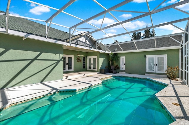 pool with a lanai, a patio, and french doors