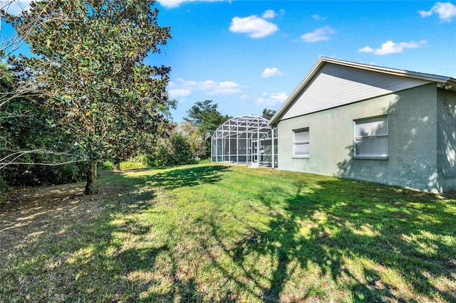 view of yard with glass enclosure