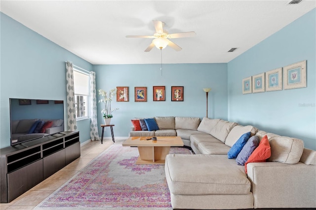 living room with visible vents, baseboards, a ceiling fan, and light tile patterned flooring