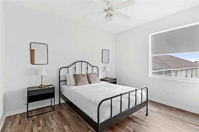 bedroom with ceiling fan, baseboards, and wood finished floors