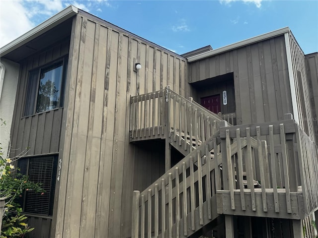 exterior space featuring stairway and board and batten siding